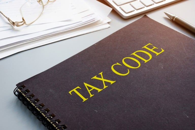 Close-up of a notepad with "tax code" written on it.