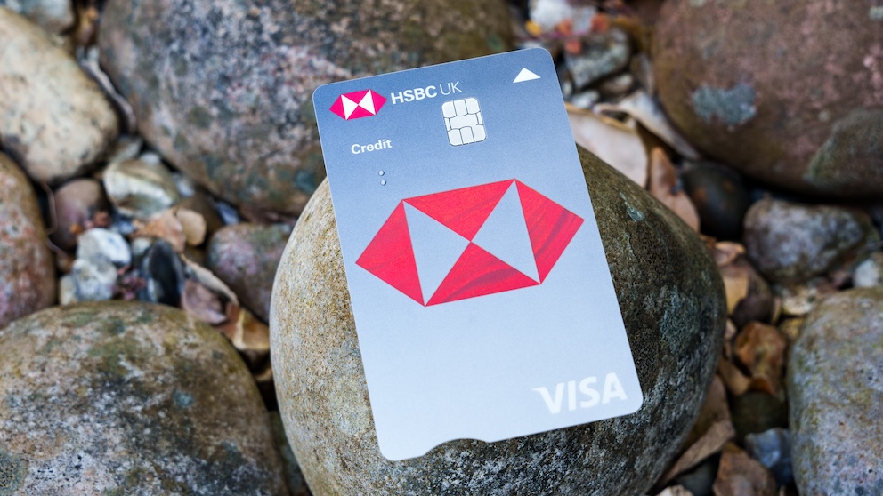 HSBC UK Visa credit card set against background of beach pebbles