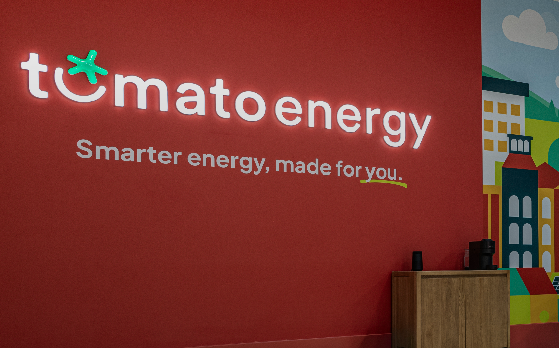 Tomato Energy logo on a wall with the statement 'Smarter energy, made for you.'