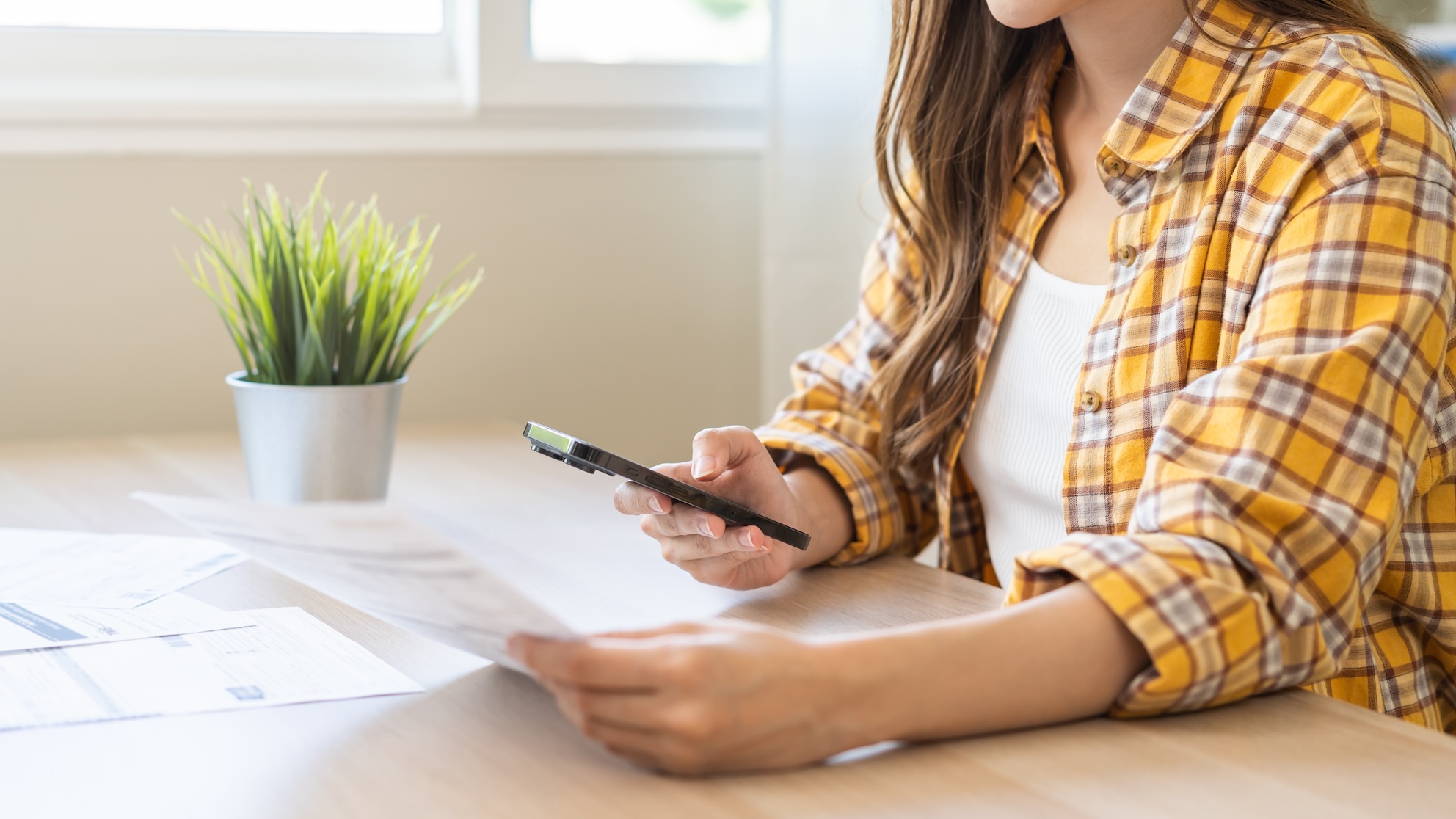 A woman checking her phone bill.