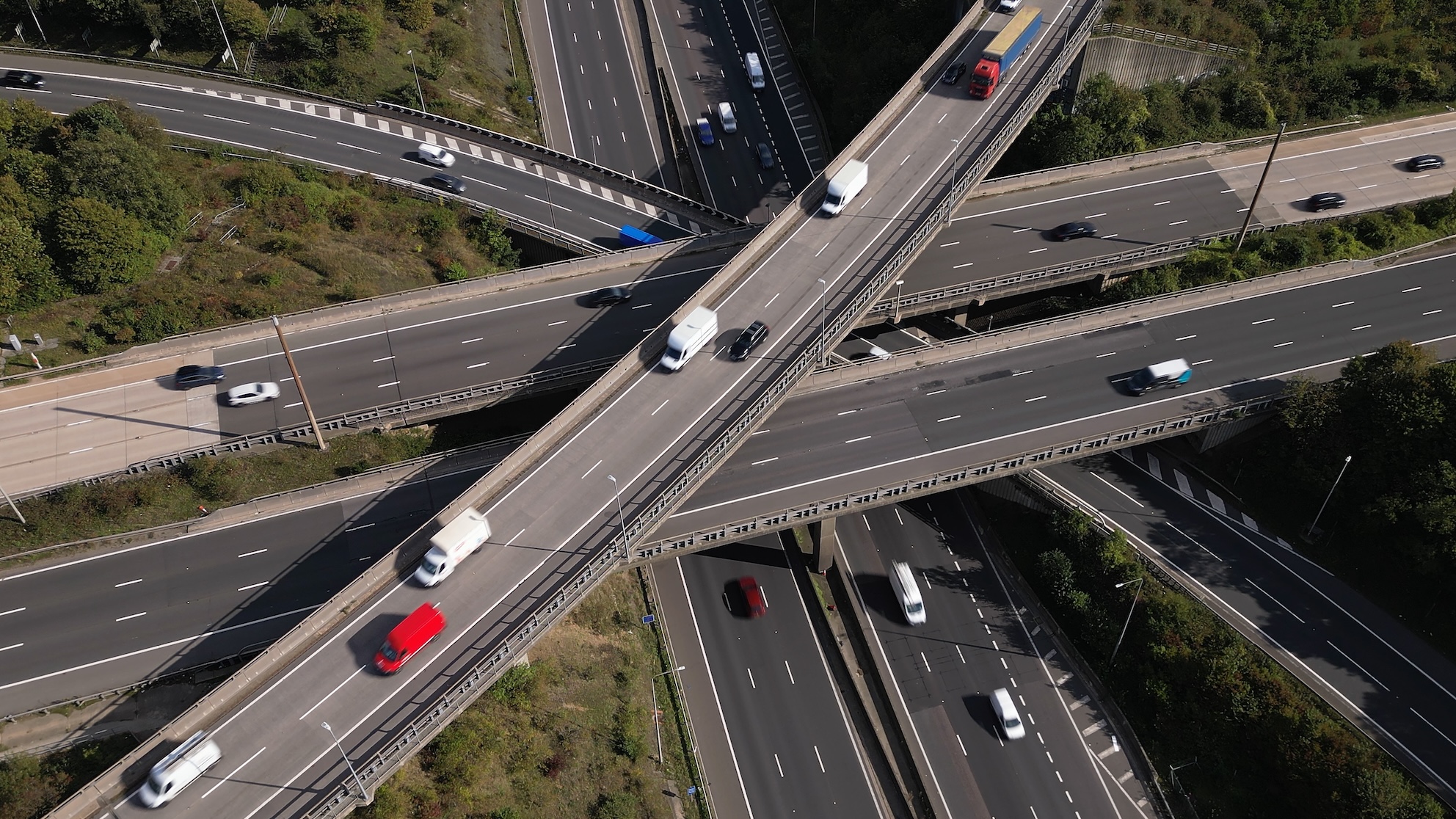 Aerial view of complex motorway junction with cars and vans driving along
