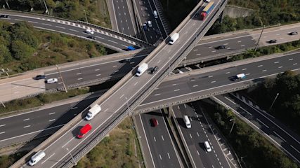 Aerial view of complex motorway junction with cars and vans driving along