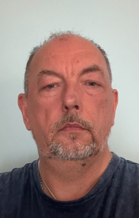 A picture of Simon Beesley (a man with a goatee, wearing a blue t-shirt)