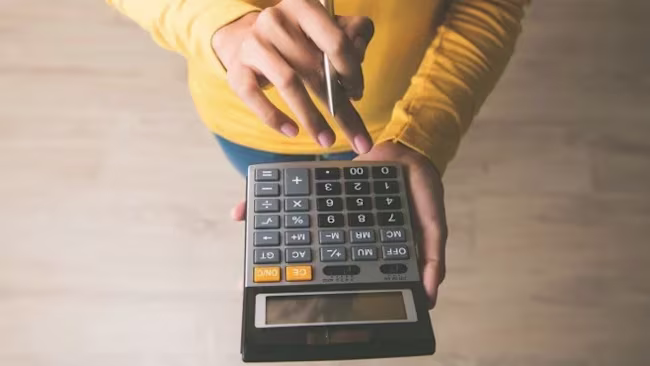 Person holding a calculator