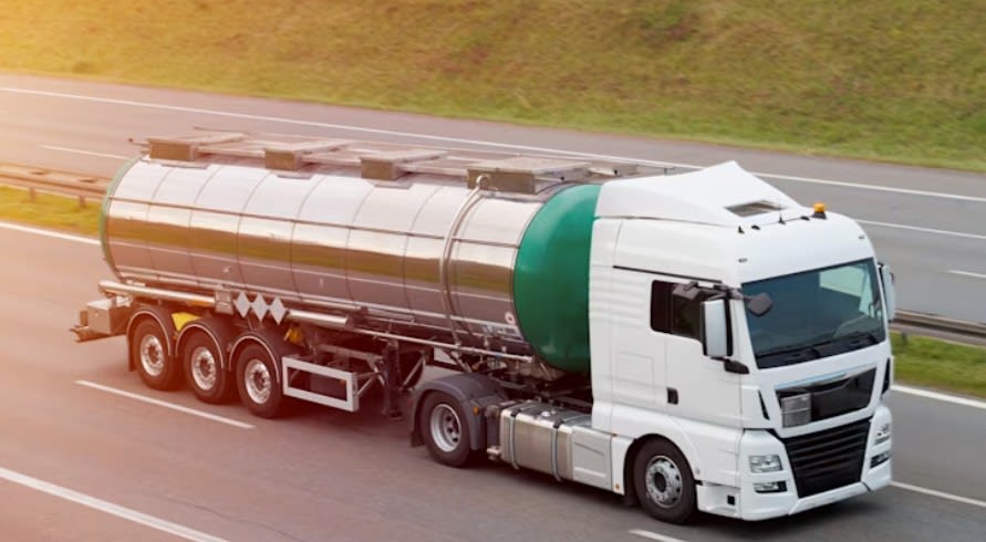 Oil truck driving along a road.