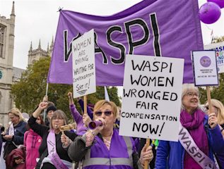 Women from the 'WASPI' campaign group protesting with a large purple sign and white posters