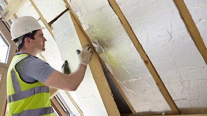 Man installing loft insulation