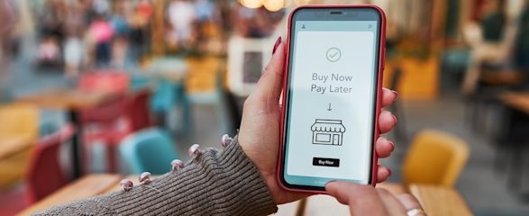 Image of mobile phone with message on it saying: 'Buy Now, Pay Later'