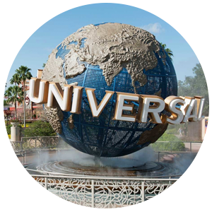 Entrance to Universal Studios, Florida. Sunny clear sky with palm trees behind the Universal sign which is the word Universal around a globe