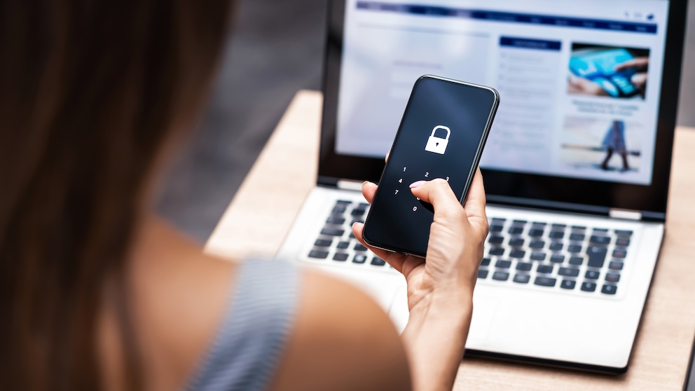Woman with mobile phone and laptop