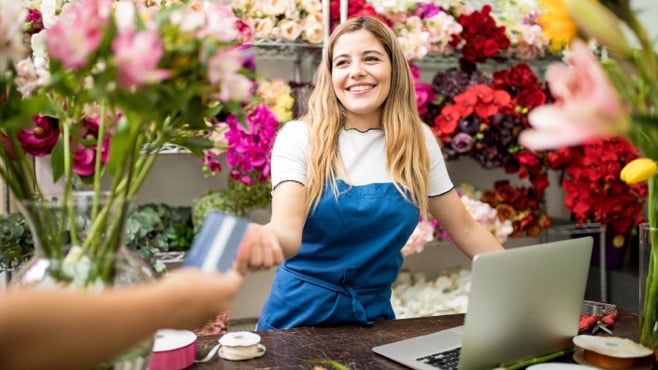 woman in flower shop taking a card payment