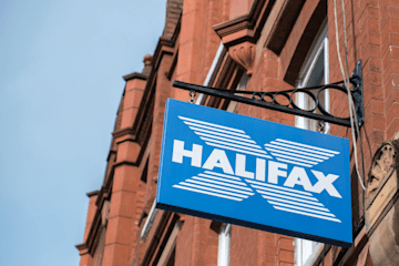 The blue Halifax logo on a sign hanging off a red-brick building
