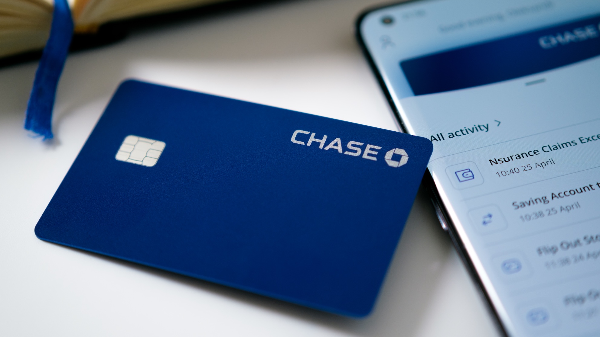 A Chase card next to a phone with the Chase app open.