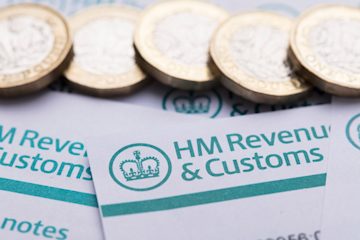 Image showing the top of an 'HMRC' headed letter with some £1 coins