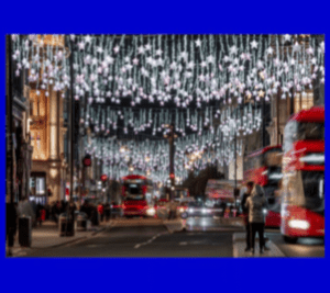 Strings of star-shaped lights hanging down over Oxford Street at night