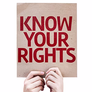 Two hands holding a placard saying "know your rights".