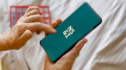 An older woman using the NS&I app on her mobile phone.