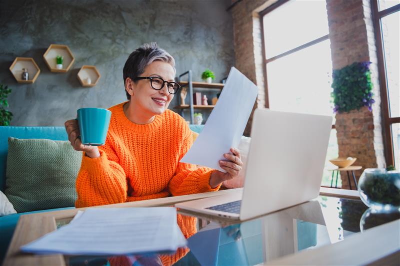 Older lady at a laptop with pension forms