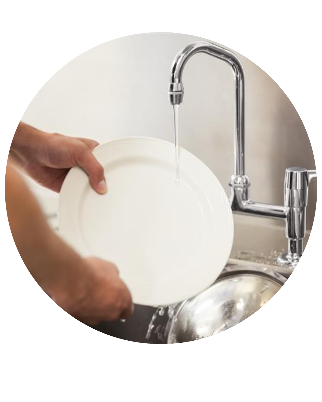 A young person washing dishes at their part-time job.