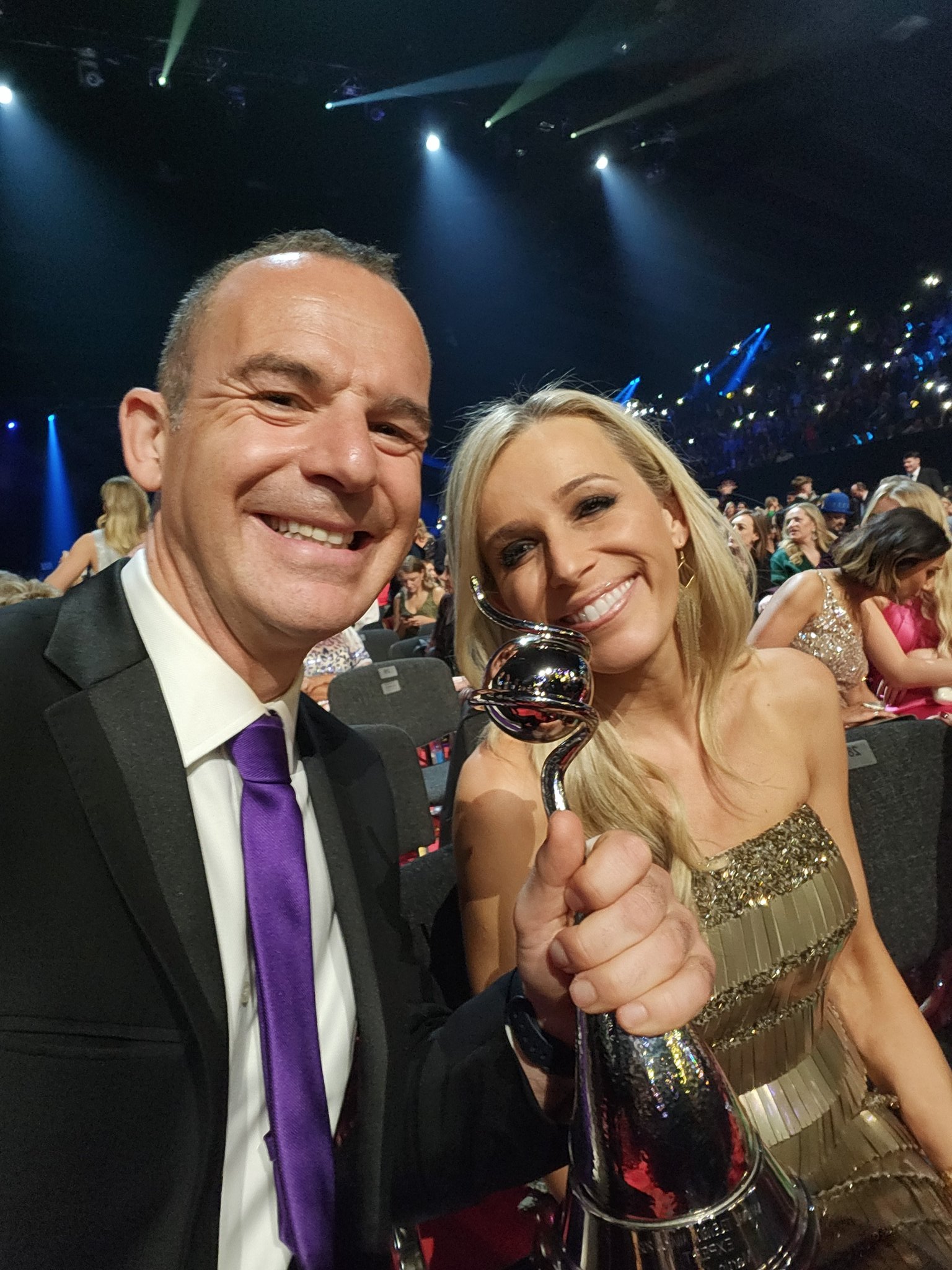 Martin Lewis with his wife Lara holding a national television award
