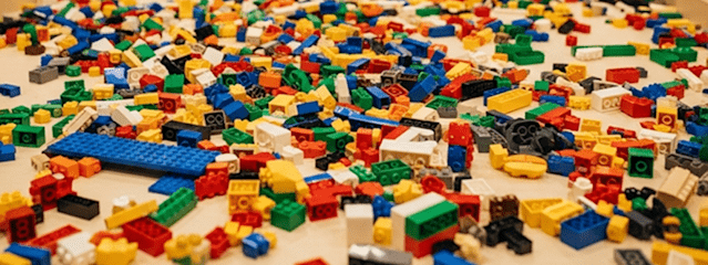 A table with lots of Lego bricks spread out on it