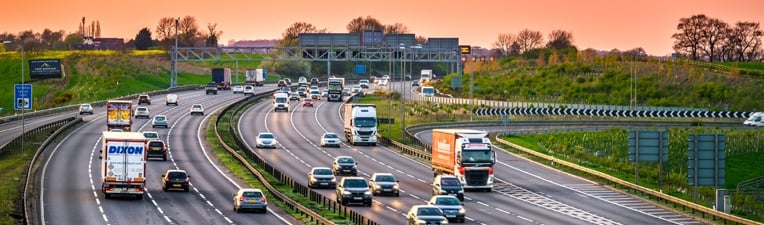 Photo of cars and lorries on a motorway at dusk.