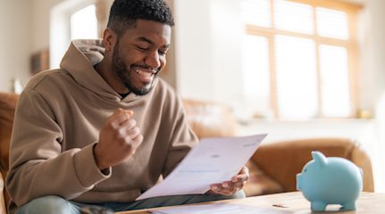 Man looking excitedly at energy bill