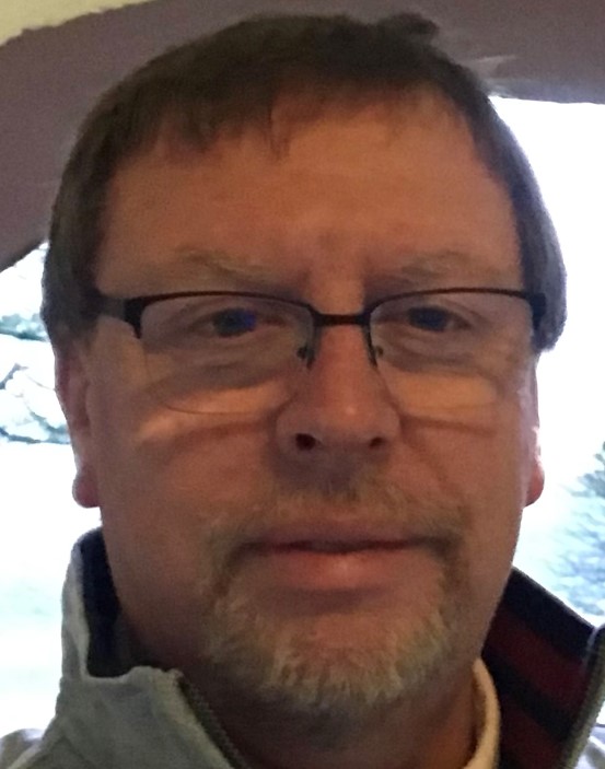 A picture of Malcolm Watson (a man with a beard, wearing glasses)