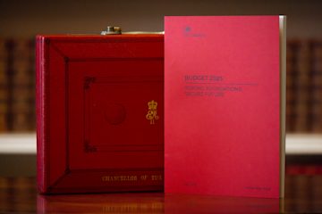 A copy of the Autumn Budget 2025, in front of the Red Budget Box, a symbolic briefcase used by the Chancellor to carry the budget speech from Downing Street to the House of Commons