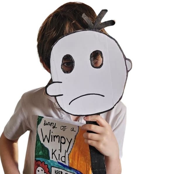 Image shows a child dressed in a home made outfit as 'Diary of a Wimpy Kid'