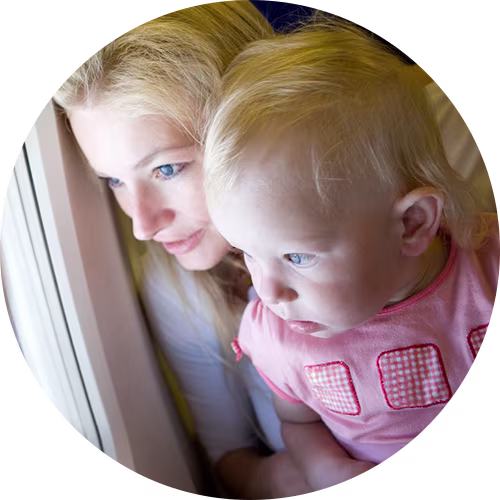 parent looking out airplane window with kid