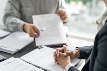 Stock image of two people in a workplace meeting
