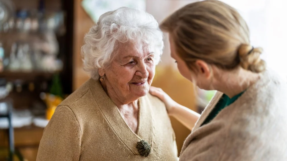 A woman caring for an elderly woman