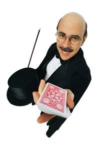 A man dressed as a magician holding up a deck of playing cards.