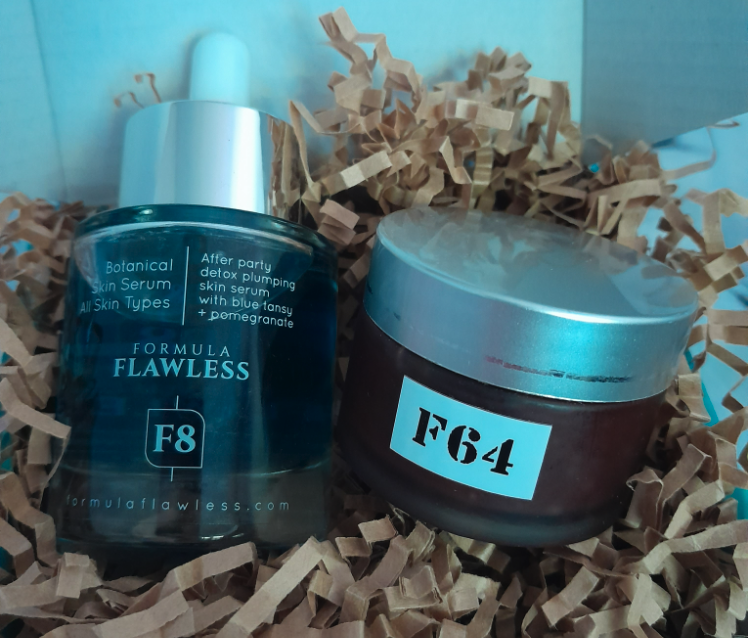 A pair of beauty products from 'Formula Flawless' nestled in brown packing strips
