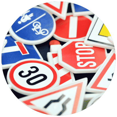 Close-up of a variety of road signs, including "30" and "stop".