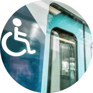 A disability sign to the left of train doors.