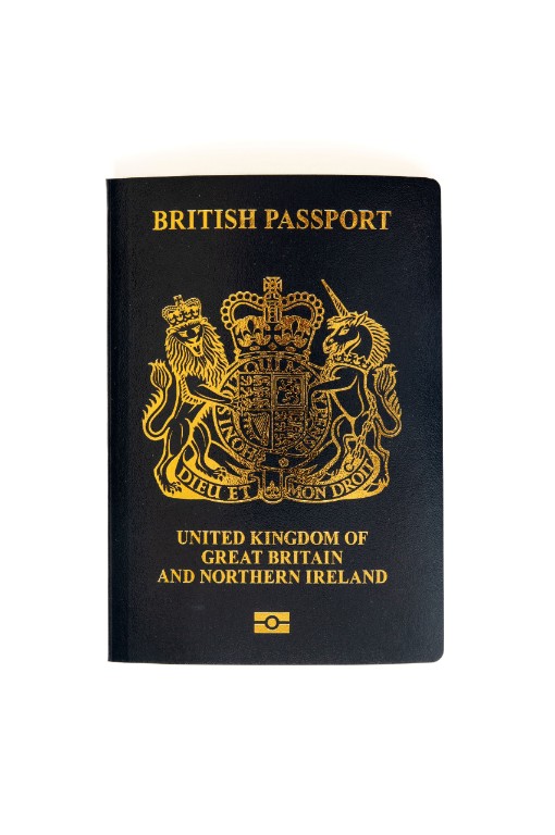 A navy blue British Passport, showing the words "British Passport. United Kingdom of Great Britain and Northern Ireland" in gold letters on its cover.