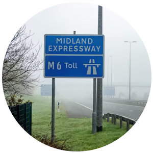 A blue road sign for the Midland Expressway M6 Toll.