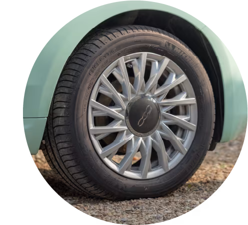 Graphic of a single car wheel stood upright with a black tyre and silver spokes.
