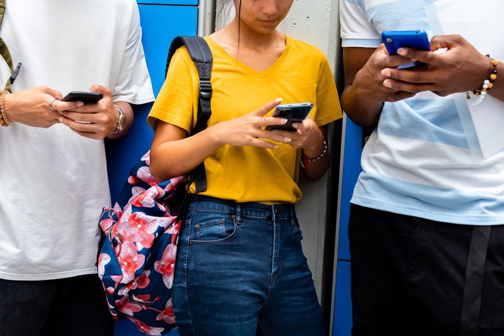 Three young people holding smartphones 