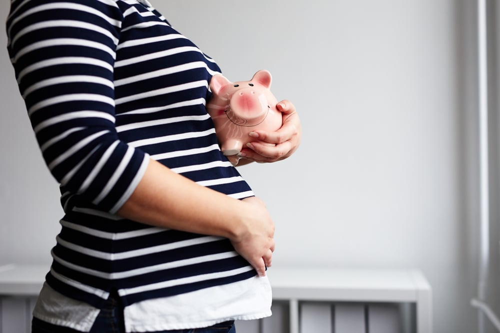pregnant-woman-holding-piggy-bank.jpg