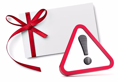 A red triangle warning sign with a black exclamation mark on it, which is overlaid on a white envelope, tied around which is a Christmassy red bow.