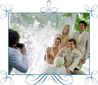 A photographer is snapping photos of the bridal party.