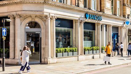 People walking past a Barclays branch