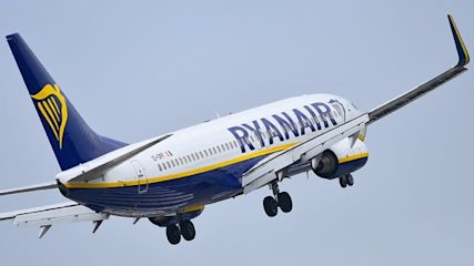 Photo of a Ryanair plane taking off taken from the rear right-hand side.