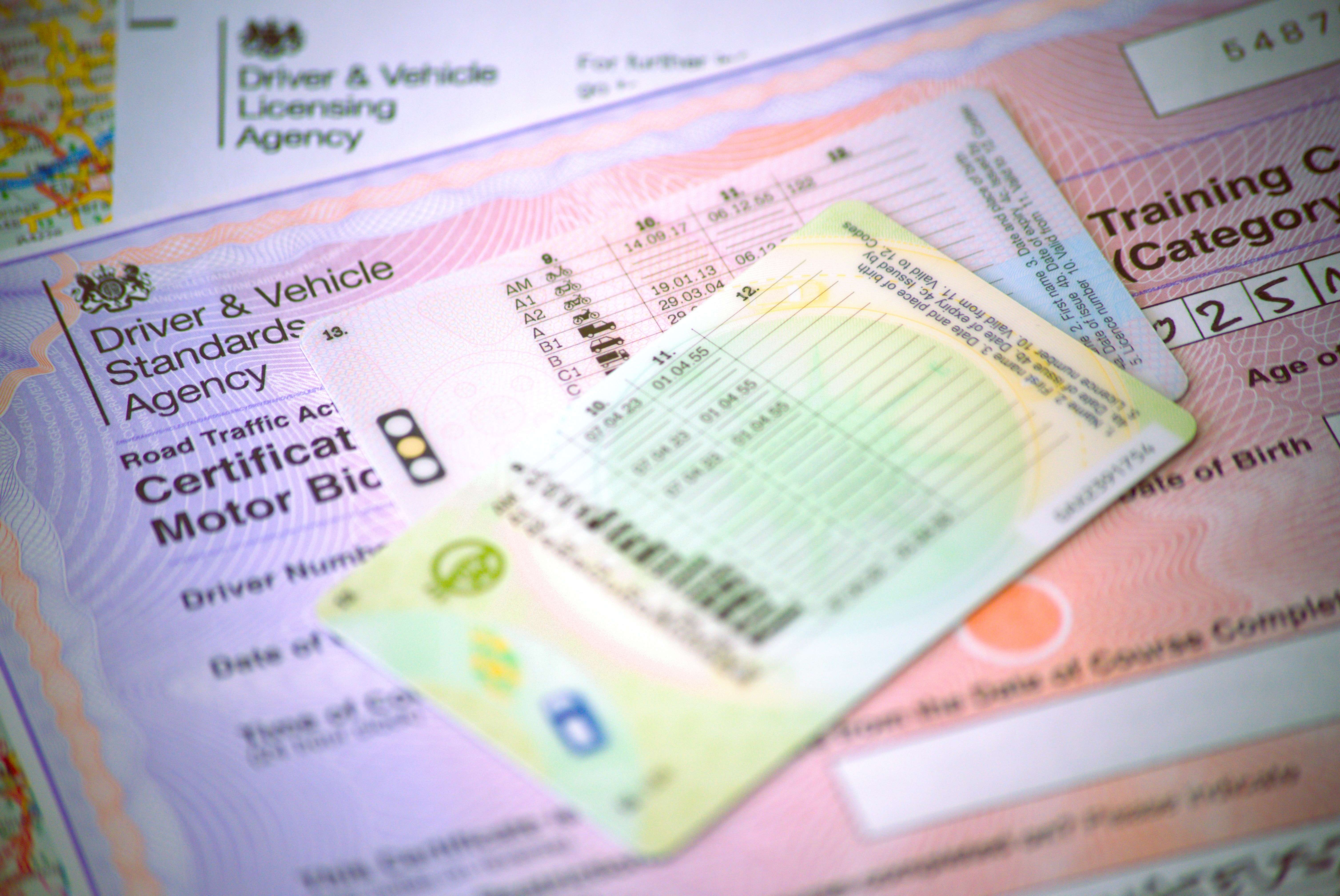 Two driving licences and other associated documentation, with one reading "Driver & Vehicle Standards Agency".