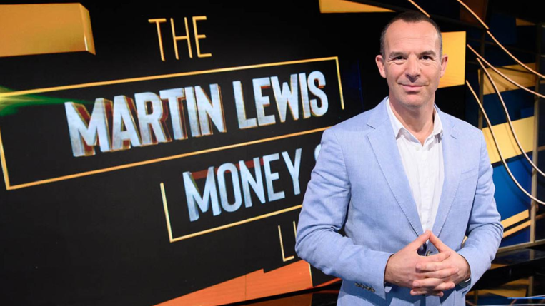 Martin Lewis in front of a digital board featuring the words "The Martin Lewis Money Show Live".