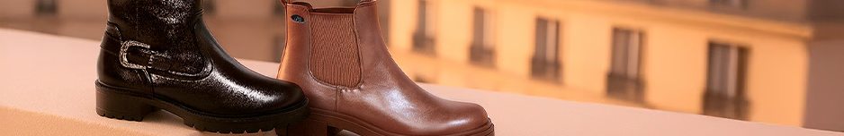 Bottines en cuir noir et marron sur fond urbain élégant.