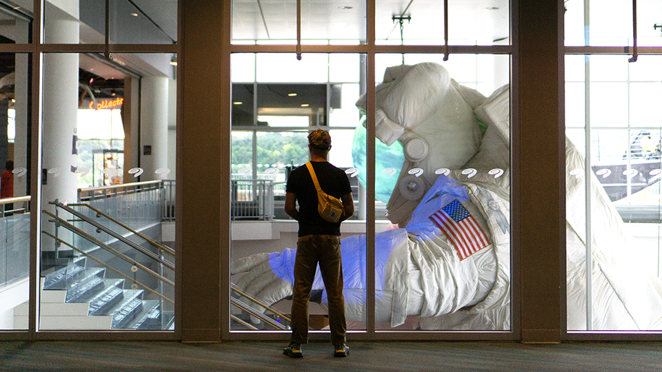 A photo of someone gazing at the Giant Astronaut from the side.